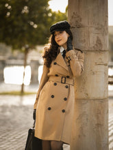 A lady wears a trench coat in Paris in winter.